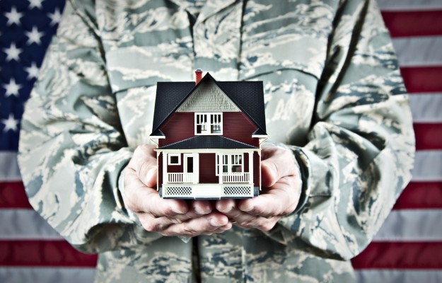 soldier holding a miniature home model